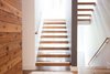 Modern home with Staircase, Wood Tread, and Wood Railing. View from the guest entry provides a focus on the open staircase and out to the tall pines beyond. Photo 6 of Dogwood Residence
