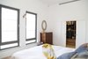 Modern home with Bedroom, Bed, Wall Lighting, and Travertine Floor. Master bedroom Photo 3 of A house in the mountains