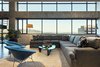 Modern home with Living Room, Coffee Tables, Chair, Floor Lighting, Sectional, and Concrete Floor. living room - looking to wasatch mountains and salt lake city beyond Photo of Governors Plaza