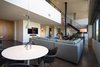 Modern home with Dining Room, Table, Chair, Pendant Lighting, Concrete Floor, and Hanging Fireplace. breakfast table - looking toward living room Photo 4 of Governors Plaza