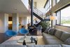 Modern home with Living Room, Coffee Tables, Chair, Sectional, Floor Lighting, Concrete Floor, Recessed Lighting, and Hanging Fireplace. living room - looking toward kitchen Photo 5 of Governors Plaza