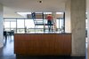 Modern home with Kitchen, Engineered Quartz Counter, Wood Cabinet, Concrete Floor, Concrete Backsplashe, and Recessed Lighting. kitchen island - looking toward staircase Photo 9 of Governors Plaza