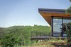Modern home with Exterior, House Building Type, Metal Roof Material, Wood Siding Material, Flat RoofLine, Shed RoofLine, and Cabin Building Type. The home's deck is perched over a canyon full of wildlife and rugged vegetation. Photo 2 of Red Hawk