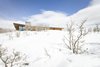 Modern home with Exterior, House Building Type, Metal Roof Material, Wood Siding Material, Flat RoofLine, Shed RoofLine, and Cabin Building Type. Warm cedar siding contrasts the snow capped ridge on a bright Utah winter day. Photo of Red Hawk