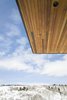 Modern home with Exterior, House Building Type, Metal Roof Material, Wood Siding Material, Flat RoofLine, and Shed RoofLine. A dramatic canopy is designed to keep the summer sun out and let the winter sun in all while protecting the home from snow and rain. Photo 6 of Red Hawk
