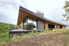 Modern home with Exterior, House Building Type, Metal Roof Material, Wood Siding Material, Flat RoofLine, and Shed RoofLine. The drawn out roof cants upward in the main living spaces to provide them with the best views. Photo 7 of Red Hawk