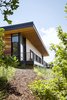 Modern home with Exterior, House Building Type, Metal Roof Material, Wood Siding Material, Shed RoofLine, and Flat RoofLine. Paths from the house connect to nearby hiking trails for outdoor and wildlife experiences. Photo 8 of Red Hawk