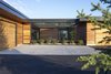 Modern home with Exterior, House Building Type, Metal Roof Material, Wood Siding Material, Flat RoofLine, and Shed RoofLine. The entry to the courtyard is screened to create visual privacy from the road and to protect the courtyard from garden noshing deer. Photo 13 of Red Hawk