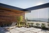 Modern home with Outdoor, Front Yard, Trees, Shrubs, Grass, Hardscapes, Walkways, Large Patio, Porch, Deck, Concrete Patio, Porch, Deck, Vertical Fences, Wall, Metal Fences, Wall, and Pavers Patio, Porch, Deck. From the interior of the courtyard the blue Uintah Mountains can be seen sprawling along the horizon. Photo 14 of Red Hawk