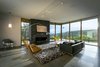 Modern home with Living Room, Chair, Sofa, Bench, Lamps, Track Lighting, Pendant Lighting, Concrete Floor, Standard Layout Fireplace, Gas Burning Fireplace, and Ottomans. Each space has a different view to create variety throughout the home. Photo 18 of Red Hawk