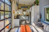 Modern home with House Building Type and Wood Siding Material. Interior. The many windows allow for maximum light throughout the day. Photo 14 of Amplified Tiny House
