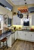 Kitchen
The kitchen has all full-sized appliances - fridge, sink, dishwasher, washer, dryer.
A recycled old bike wheel is now used to crank the pot rack up and down in the kitchen. Photo 17 of Amplified Tiny House modern home