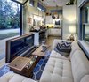 Modern home with Living Room, Sofa, Sectional, and Table Lighting. When this custom-made coffee table is open, it becomes a video editing desk with built-in drawers Photo 16 of Amplified Tiny House