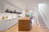 Modern home with Kitchen, Marble Counter, White Cabinet, Light Hardwood Floor, Ceiling Lighting, Stone Slab Backsplashe, Undermount Sink, Marble Backsplashe, and Wood Counter. Kitchen Photo of Ritchie Rowhouse