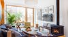 Modern home with Living Room, Bench, End Tables, Sofa, Coffee Tables, Chair, Ceiling Lighting, Light Hardwood Floor, Gas Burning Fireplace, and Rug Floor. Living room Photo 5 of Ritchie Rowhouse