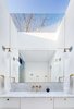 Modern home with Bath Room, Marble Counter, Marble Floor, Undermount Sink, Marble Wall, One Piece Toilet, Wall Lighting, and Accent Lighting. Master bath with reflected skylight Photo 8 of Ritchie Rowhouse