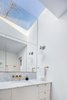 Modern home with Bath Room, Marble Counter, Marble Floor, Undermount Sink, Wall Lighting, Accent Lighting, Marble Wall, and One Piece Toilet. Master bath with reflected skylight Photo 9 of Ritchie Rowhouse