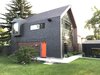 Modern home with Exterior, Apartment Building Type, Shingles Roof Material, and Green Roof Material. West Elevation - Mirror and Hemp Shake Siding Photo of Calder Laneway House - Edmonton