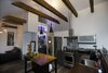 Modern home with Kitchen, Wood Counter, Ceiling Lighting, Accent Lighting, Laminate Cabinet, Vinyl Floor, Ceramic Tile Backsplashe, Pendant Lighting, Refrigerator, Range, Range Hood, Dishwasher, and Drop In Sink. Calder - Interior 1 - Kitchen / Living Room Photo 3 of Calder Laneway House - Edmonton