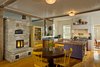 Locally harvested stone was used for the masonry heater. This is also the architectural focus of the main living area. Photo 4 of Barn Reinvented - LEED Platinum Home modern home