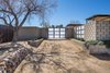 Modern home with Plywood Floor, Carpet Floor, Front Yard, Desert, Trees, Shrubs, Hardscapes, Vertical Fences, Wall, Landscape Lighting, Post Lighting, and Outdoor. Front Entry showing decorative block walls with open perforations and protruding details. Concrete block, metal with wood detail age well in the desert environment. Photo of Modern Jewel in the Desert