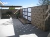Modern home with Outdoor, Side Yard, Hardscapes, Small Patio, Porch, Deck, Concrete Patio, Porch, Deck, and Horizontal Fences, Wall. Enclosed patio showing the degrees of light Photo 7 of Modern Jewel in the Desert
