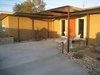 Modern home with Outdoor, Back Yard, Desert, Walkways, Shrubs, and Stone Patio, Porch, Deck. Decorative metal/wood structure defines the entry. Photo 8 of Modern Jewel in the Desert