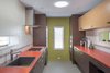 Modern home with Kitchen, Wood Cabinet, Ceramic Tile Floor, Ceramic Tile Backsplashe, Laminate Counter, Subway Tile Backsplashe, Ceiling Lighting, Refrigerator, Wall Oven, Cooktops, Drop In Sink, Range, and Range Hood. Guest Kitchen has Gaggenau cooktop, Han Grohe faucet with Stainless steel Kohler sink. Photo 16 of Modern Jewel in the Desert