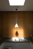 Modern home with Kitchen, Metal Counter, White Cabinet, Metal Backsplashe, Ceiling Lighting, Drop In Sink, Cork Floor, and Pendant Lighting. Kitchenette Photo 10 of Hiss Studio