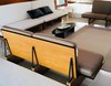 Modern home with Living Room, Rug Floor, Chair, Bench, End Tables, Sofa, Coffee Tables, and Terrazzo Floor. Chair detail: the furniture was originally positioned along the top edge of the conversation pit. Photo 5 of David Cohen House