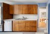 Modern home with Kitchen, Laminate Counter, Recessed Lighting, Drop In Sink, Wine Cooler, Dishwasher, Linoleum Floor, and Wood Cabinet. Umbrella House, kitchen Photo 8 of Umbrella House
