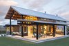 Modern home with Grass, Shrubs, Front Yard, Sofa, Coffee Tables, Wood Burning Fireplace, Concrete Floor, Bed, Ceiling Lighting, Range, Drop In Sink, Refrigerator, Range Hood, Marble Counter, and Outdoor. "The central pavilion evolved as a place to house a lot of the functions of the home, and also gave us a structure to build porches and decks for further protection from the sun," says Dominick. The outdoor patio is 1,600 square feet. Photo 8 of Yurt-Inspired Home on the Range