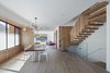 Modern home with Dining Room, Chair, Table, Medium Hardwood Floor, Pendant Lighting, Ceiling Lighting, and Light Hardwood Floor. Dining area between frosted glass light-well and Central Stair with Family Room and backyard beyond. Photo 5 of Noe Valley House