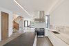 Modern home with Medium Hardwood Floor, Recessed Lighting, and Pendant Lighting. Kitchen, looking toward Central Stair and Dining area. Photo 11 of Noe Valley House