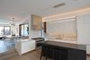 Modern home with Ceiling Lighting, Recessed Lighting, Medium Hardwood Floor, and Pendant Lighting. Kitchen, looking to Dining and Living areas beyond. Photo 12 of Noe Valley House