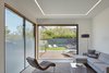 Modern home with Living Room, Coffee Tables, Ceiling Lighting, Medium Hardwood Floor, Recliner, and Recessed Lighting. Family area, open to back yard. Photo 14 of Noe Valley House