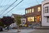 Modern home with Exterior, Flat RoofLine, Wood Siding Material, and House Building Type. View of house amongst neighbors along street. Photo of Noe Valley House
