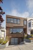 Modern home with Exterior, Flat RoofLine, Wood Siding Material, and House Building Type. "The subtly angled facade design was created by adapting to different setbacks of the neighboring houses, and as a response to the downhill views to the east," says IwamotoScott Architecture. The facade of the Noe Valley House simultaneously stands out and blends in with its neighbors. Photo 2 of Noe Valley House