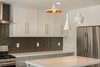 Modern home with Kitchen, Engineered Quartz Counter, White Cabinet, Quartzite Counter, Wood Cabinet, Refrigerator, Range, Recessed Lighting, Glass Tile Backsplashe, Pendant Lighting, and Range Hood. Tom Dixon' Beat pendants Photo 11 of Briarwood Place