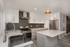 Modern home with Kitchen, Engineered Quartz Counter, Quartzite Counter, White Cabinet, Wood Cabinet, Glass Tile Backsplashe, Pendant Lighting, Recessed Lighting, Refrigerator, Range, and Range Hood. The island surface is Covelano marble Photo 10 of Briarwood Place