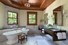 The 7,000-square-foot two-story Grove Lodge incorporates the use of native stone and natural finishes to help it blend into the scenic landscape of the Mohonk Mountain House property.
Interior spaces include hardwood floors and the use of exposed wood throughout. The guest rooms have their own separate drive-up entrances and feature either a stone patio (lower level) or balcony area. All areas are appointed with our rustic rocking chairs for outdoor seating.
Eco-friendly features include sustainable building materials, LED lighting, and a geo- thermal heating and cooling system. 250-tons of Shawangunk conglomerate excavated from the site have been recycled into the retaining walls and the stone fireplace. Photo 4 of Grove Lodge at Mohonk Mountain House modern home