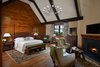 The 7,000-square-foot two-story Grove Lodge incorporates the use of native stone and natural finishes to help it blend into the scenic landscape of the Mohonk Mountain House property.
Interior spaces include hardwood floors and the use of exposed wood throughout. The guest rooms have their own separate drive-up entrances and feature either a stone patio (lower level) or balcony area. All areas are appointed with our rustic rocking chairs for outdoor seating.
Eco-friendly features include sustainable building materials, LED lighting, and a geo- thermal heating and cooling system. 250-tons of Shawangunk conglomerate excavated from the site have been recycled into the retaining walls and the stone fireplace. Photo 2 of Grove Lodge at Mohonk Mountain House modern home