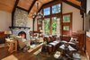 The 7,000-square-foot two-story Grove Lodge incorporates the use of native stone and natural finishes to help it blend into the scenic landscape of the Mohonk Mountain House property.
Interior spaces include hardwood floors and the use of exposed wood throughout. The guest rooms have their own separate drive-up entrances and feature either a stone patio (lower level) or balcony area. All areas are appointed with our rustic rocking chairs for outdoor seating.
Eco-friendly features include sustainable building materials, LED lighting, and a geo- thermal heating and cooling system. 250-tons of Shawangunk conglomerate excavated from the site have been recycled into the retaining walls and the stone fireplace. Photo of Grove Lodge at Mohonk Mountain House modern home