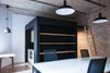 Modern home with Living Room, Pendant Lighting, and Ceiling Lighting. "Black Cube" contains bathroom and kitchen with sleeping loft on the top Photo 5 of Startup office in Prezlauer Berg