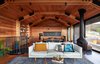 Modern home with Living Room, Accent Lighting, Coffee Tables, Table, Pendant Lighting, Ceiling Lighting, Hanging Fireplace, Sofa, Medium Hardwood Floor, Chair, Rug Floor, and Track Lighting. In Lorne, Victoria, Austin Maynard Architects gave an old shack near the beach a modern revamp and a timber extension that allows for elevated sea views. With interiors lined in recycled Silvertop Ash, the house oozes a cozy, cabin-like feel. Photo 3 of Dorman House