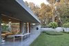 Modern home with Outdoor, Back Yard, Trees, Grass, Concrete Patio, Porch, Deck, Hanging Lighting, Shrubs, Concrete Fences, Wall, and Horizontal Fences, Wall. At the family home of an Israeli architect, modern and light-filled interiors enliven a brutalist, raw concrete structure.
Located in the city of Ramat HaSharon near Tel Aviv, the home that Pitsou Kedem designed for himself and his family boasts a powerful and striking horizontal form with a low silhouette. Photo 9 of House of an Architect