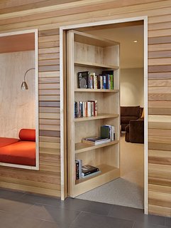 The empty nesters who own this house on Lake Wenatchee in Washington wanted a home that could accommodate their college-aged kids and their friends when they visit. Architect John Deforest created a secret media room hidden behind a door with a bookshelf in the front, giving the couple a place to keep their books, as well as their visiting children and guests.