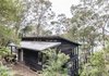 Modern home with Exterior, Wood Siding Material, House Building Type, and Shed RoofLine. North of Sydney on Dangar Island is a modern Australian vacation rental that's positioned to take full advantage of views of the Hawkesbury River and gorgeous native Angophora trees. Photo of Dangar Island House
