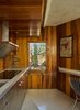 Modern home with Kitchen, Concrete Counter, Cooktops, Wood Backsplashe, Concrete Floor, Range Hood, Carpet Floor, and Recessed Lighting. Sited in a remote desert residence built by Lautner almost 70 years ago, the property was commissioned by Hollywood movie producer Lucien Hubbard who wanted a holiday retreat where he could escape from L.A. with actress Mary Pickford. Photo 4 of The Lautner