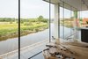 Modern home with Windows. Perched along the banks of the River Ouse near the historic English town of Lewes is a Cor-Ten steel house with a Photo 7 of Cor-Ten Steel-Clad Prefab